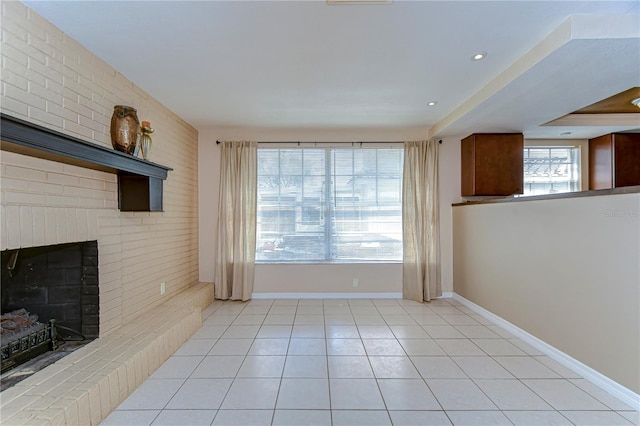 unfurnished living room featuring baseboards, light tile patterned flooring, and a fireplace