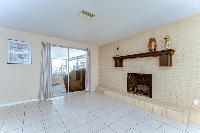 unfurnished living room featuring a brick fireplace, light tile patterned floors, baseboards, and visible vents