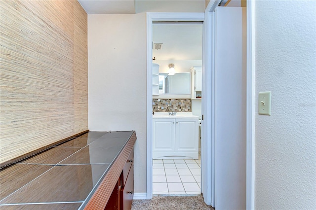 bathroom with tasteful backsplash, visible vents, and vanity