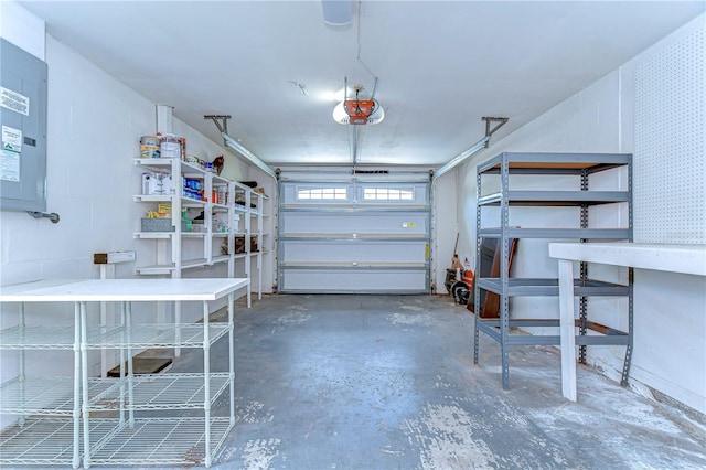 garage featuring concrete block wall and a garage door opener