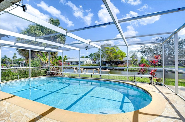 pool featuring a lanai, a patio area, and a water view