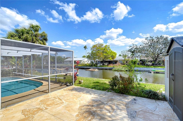 view of patio / terrace featuring a lanai, an outdoor pool, and a water view