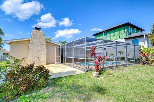 exterior space featuring a lanai, a chimney, a yard, an outdoor pool, and a patio