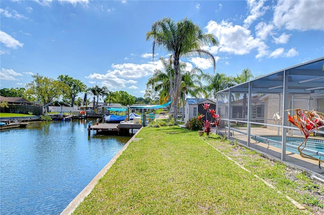 view of dock with an outdoor pool, a lanai, a lawn, and a water view