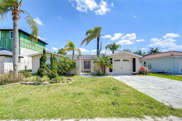 view of front of house featuring concrete driveway, a garage, and a front yard