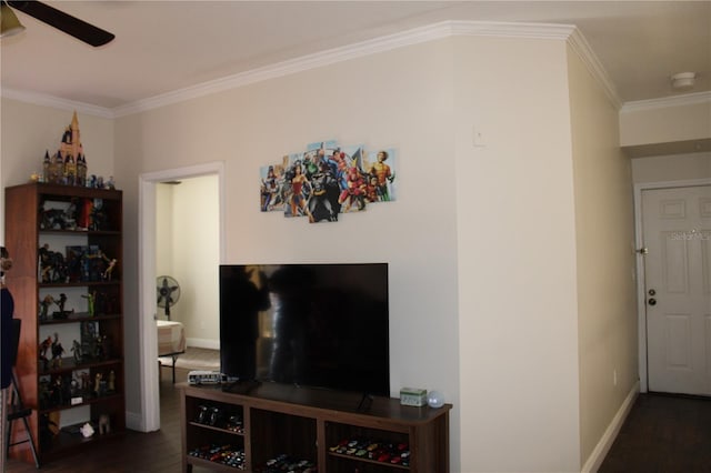 living room featuring baseboards, dark wood-type flooring, a ceiling fan, and ornamental molding