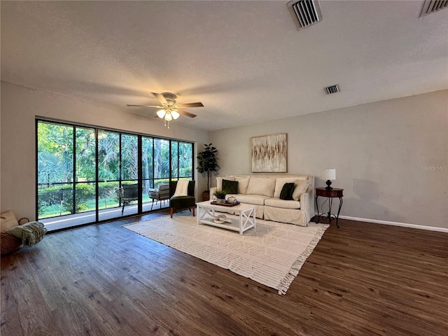 610 S Woodlands Dr, Oldsmar, FL 34677 - living room featuring a ceiling fan, baseboards, visible vents, and wood finished floors