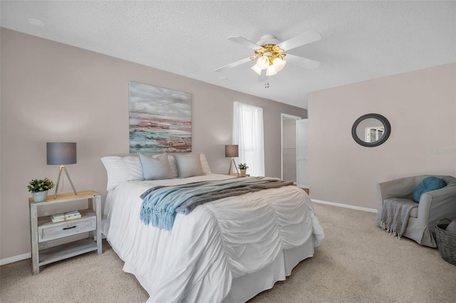 2462 Indian Trl E, Palm Harbor, FL 34683 - bedroom featuring light colored carpet, baseboards, ceiling fan, and a textured ceiling
