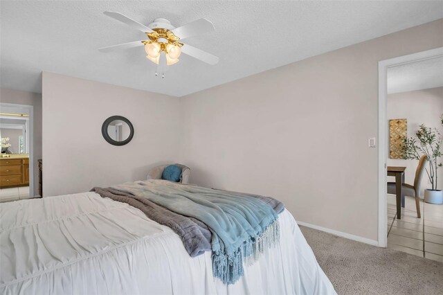 2462 Indian Trl E, Palm Harbor, FL 34683 - bedroom with light carpet, baseboards, and a ceiling fan