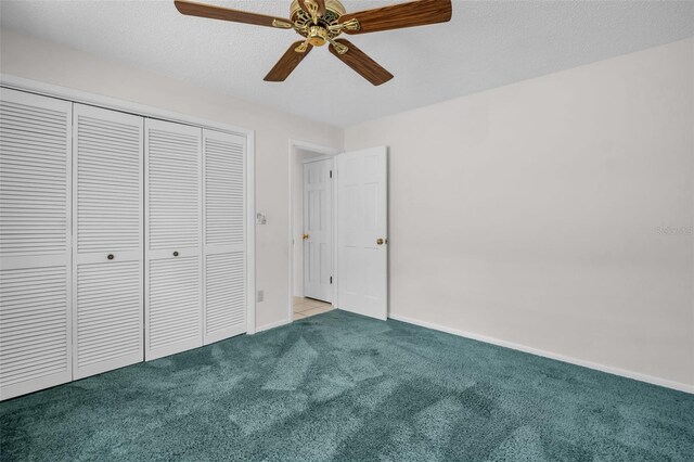 2462 Indian Trl E, Palm Harbor, FL 34683 - unfurnished bedroom with carpet floors, a closet, baseboards, and ceiling fan