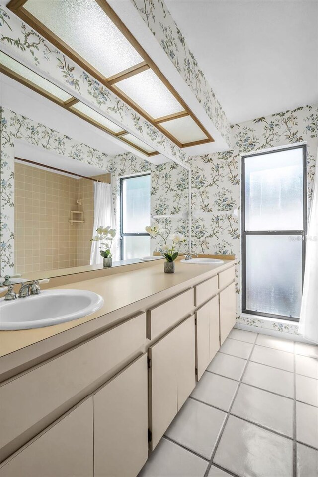 2462 Indian Trl E, Palm Harbor, FL 34683 - bathroom with wallpapered walls, double vanity, tile patterned floors, and a shower with curtain
