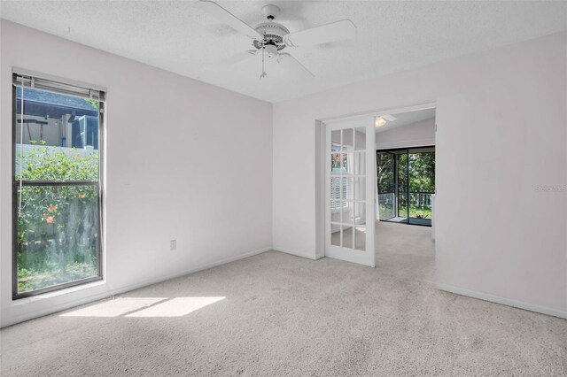 2462 Indian Trl E, Palm Harbor, FL 34683 - empty room featuring carpet flooring, a ceiling fan, baseboards, and a textured ceiling