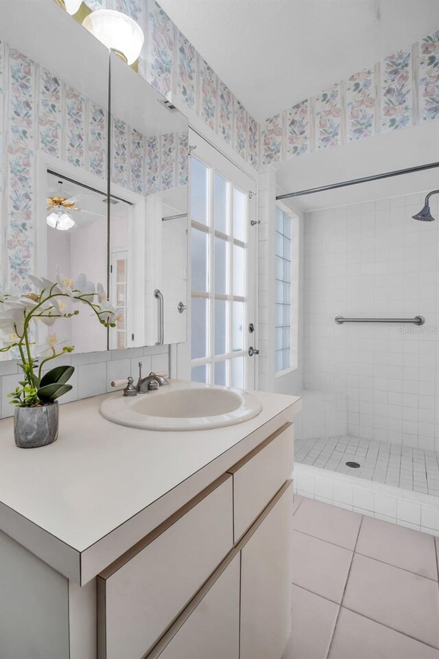 2462 Indian Trl E, Palm Harbor, FL 34683 - full bath with a stall shower, vanity, tile patterned floors, and wallpapered walls