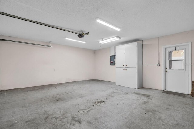 2462 Indian Trl E, Palm Harbor, FL 34683 - garage with a garage door opener and electric panel