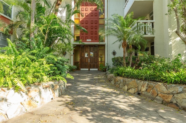 entrance to property featuring stucco siding