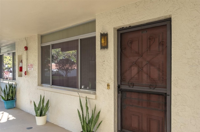 property entrance featuring stucco siding