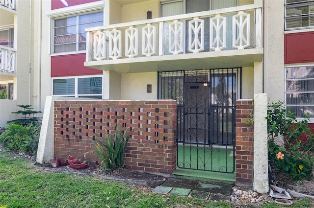 entrance to property with brick siding and stucco siding