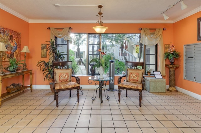 sitting room featuring light tile patterned floors, track lighting, crown molding, and baseboards