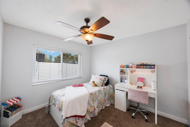 carpeted bedroom featuring baseboards, a textured ceiling, and a ceiling fan