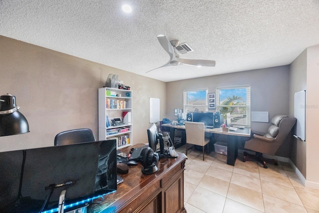 office featuring light tile patterned floors, a ceiling fan, visible vents, and a textured ceiling