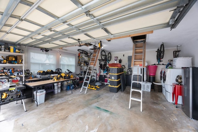 garage with independent washer and dryer and a workshop area