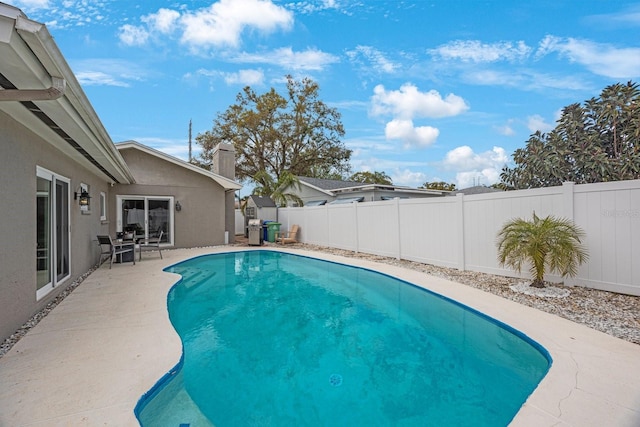 view of pool with a patio area, a fenced in pool, and a fenced backyard