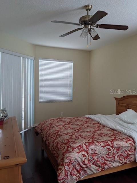 bedroom with a textured ceiling and ceiling fan