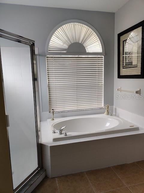 full bathroom with tile patterned floors, a stall shower, and a bath