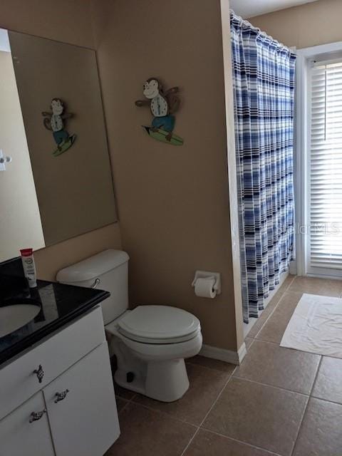 full bath featuring tile patterned floors, plenty of natural light, vanity, and a shower with shower curtain