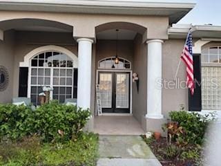 entrance to property with stucco siding