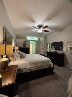 carpeted bedroom featuring a textured ceiling and ceiling fan