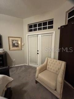 sitting room with baseboards and carpet floors