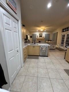 kitchen featuring light tile patterned floors, a peninsula, and light countertops