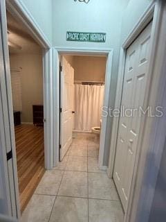 corridor featuring light tile patterned floors