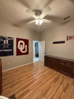 spare room featuring visible vents, baseboards, light wood-type flooring, and ceiling fan