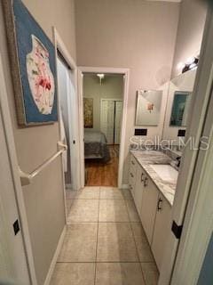 full bath with tile patterned flooring, double vanity, ensuite bath, and a sink