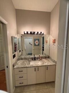 bathroom featuring tile patterned flooring and vanity