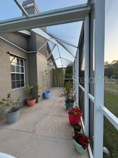 view of side of home featuring a lanai and a patio area