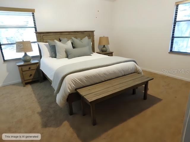 bedroom with multiple windows, baseboards, and light carpet