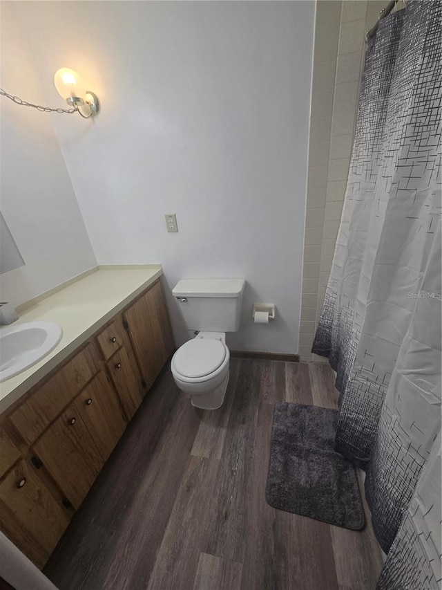 full bath with vanity, a shower with curtain, toilet, and wood finished floors