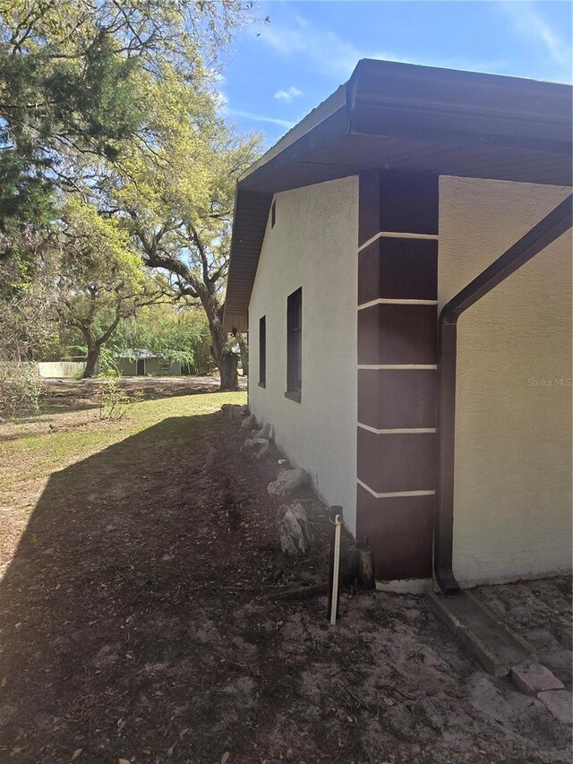 view of side of property with stucco siding