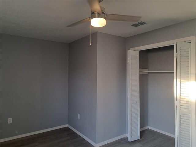 26 Clintwood Ave, Englewood, FL 34223 - unfurnished bedroom with dark wood-type flooring, a closet, and ceiling fan