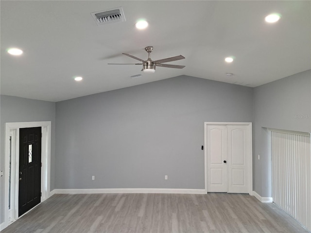 26 Clintwood Ave, Englewood, FL 34223 - unfurnished living room with a ceiling fan, light wood-type flooring, vaulted ceiling, and recessed lighting