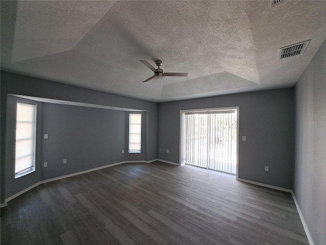 26 Clintwood Ave, Englewood, FL 34223 - empty room featuring ceiling fan, dark wood finished floors, a textured ceiling, and a raised ceiling