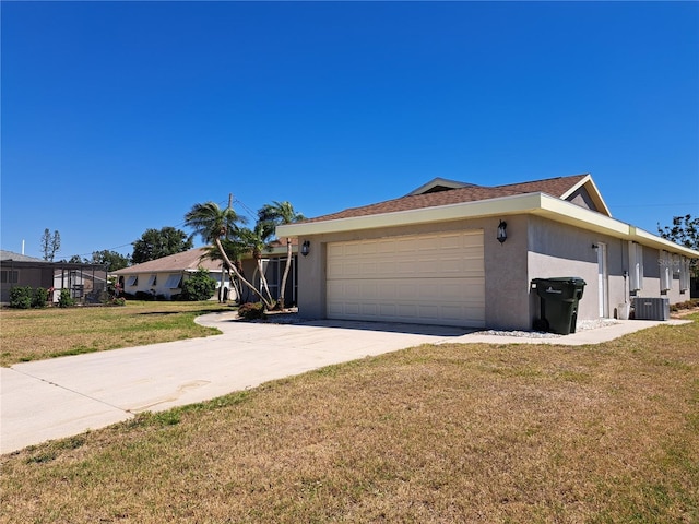 26 Clintwood Ave, Englewood, FL 34223 - view of side of home featuring stucco siding, an attached garage, driveway, and a lawn