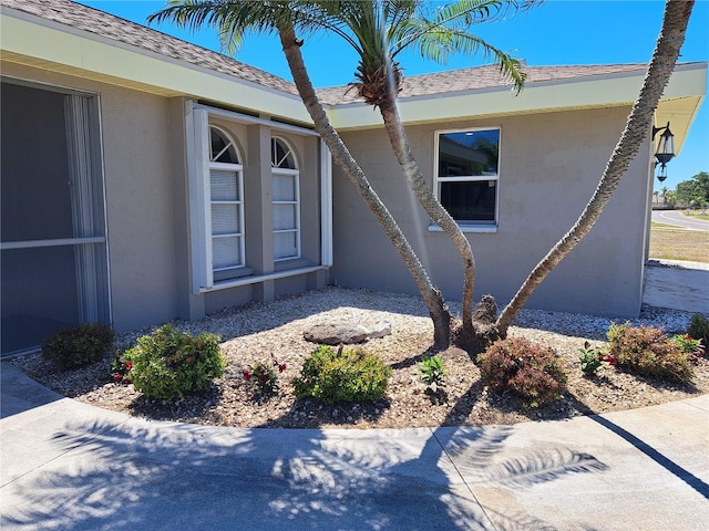26 Clintwood Ave, Englewood, FL 34223 - entrance to property featuring stucco siding and a shingled roof