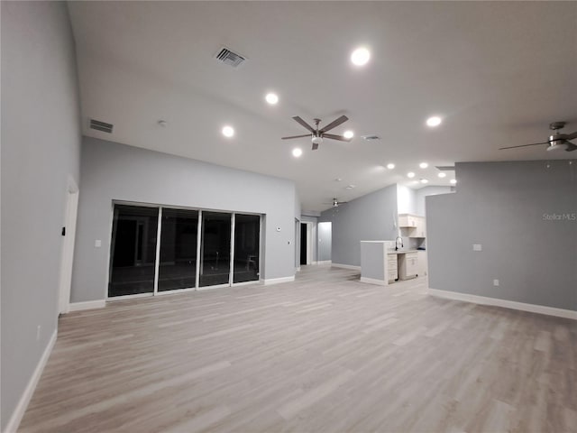 26 Clintwood Ave, Englewood, FL 34223 - unfurnished living room with ceiling fan, vaulted ceiling, light wood-style floors, and recessed lighting