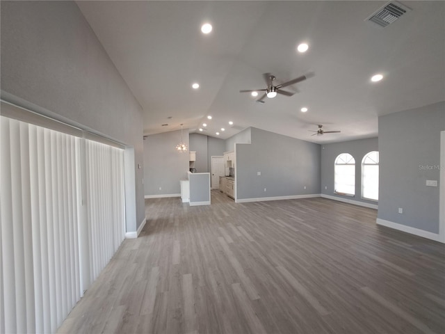 26 Clintwood Ave, Englewood, FL 34223 - unfurnished living room featuring vaulted ceiling, a ceiling fan, recessed lighting, light wood-style flooring, and a chandelier