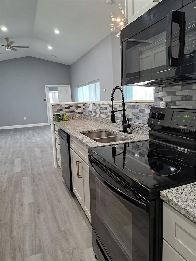 26 Clintwood Ave, Englewood, FL 34223 - kitchen featuring black appliances, backsplash, white cabinets, ceiling fan, and light wood-type flooring