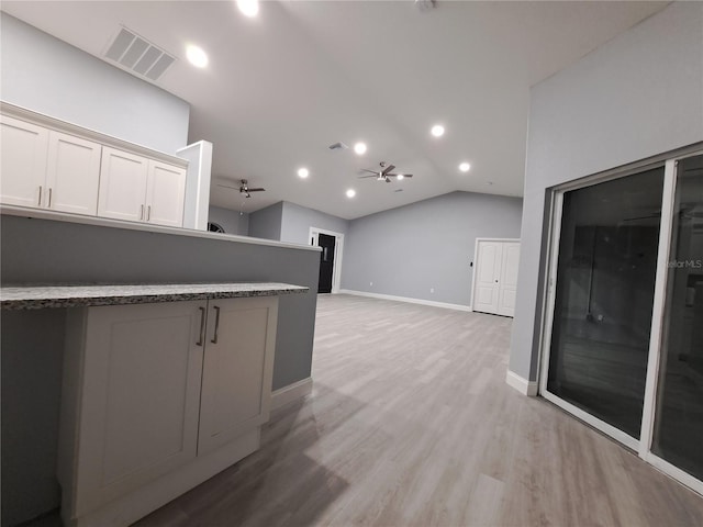 26 Clintwood Ave, Englewood, FL 34223 - kitchen with a ceiling fan, lofted ceiling, light wood-type flooring, white cabinetry, and recessed lighting